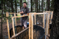 Man standing in a shoreline mesocosm