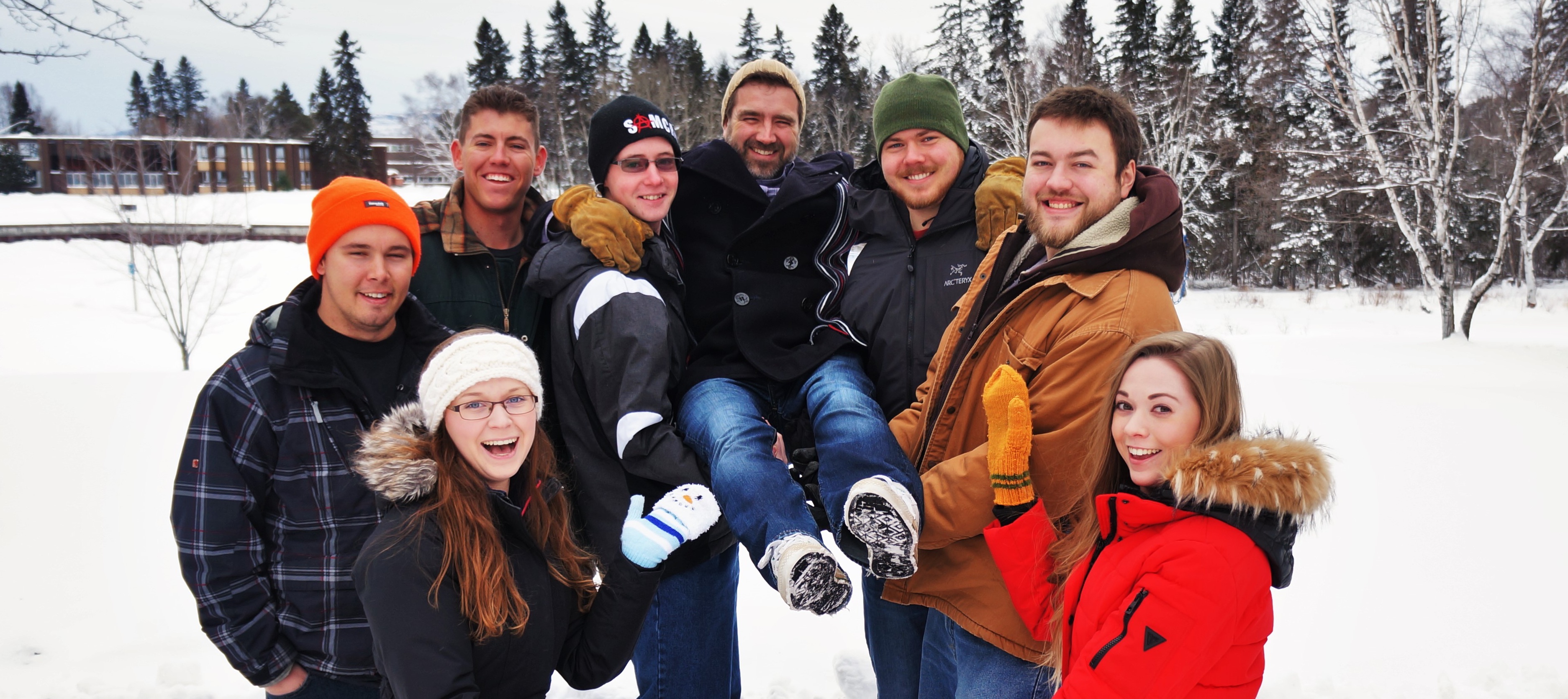 man being held by several people
