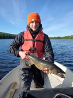 Man holding a fish in a boat
